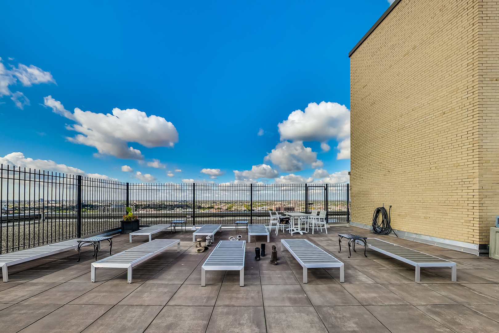 2930 North Sheridan Road, Unit 2111 Chicago, IL 60657 - Photo 21 of 31 a view of a patio with couches and table with potted plants