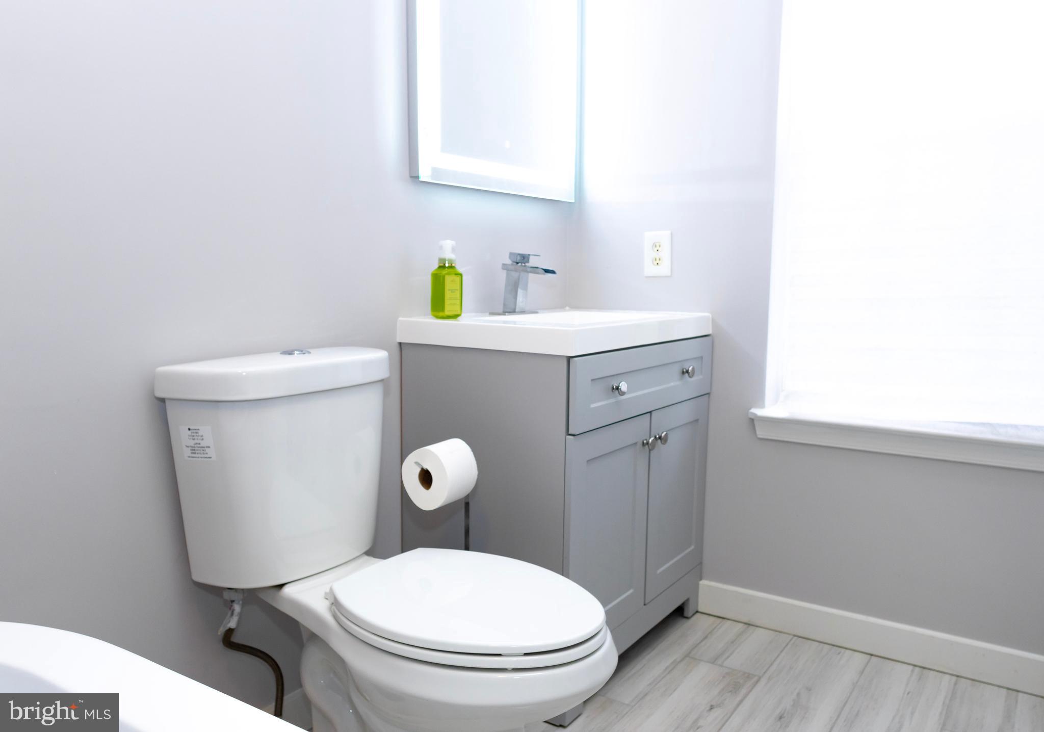 2429 Lizbec Court Crofton, MD 21114 - Photo 15 of 31 a white toilet sitting next to a bathroom sink