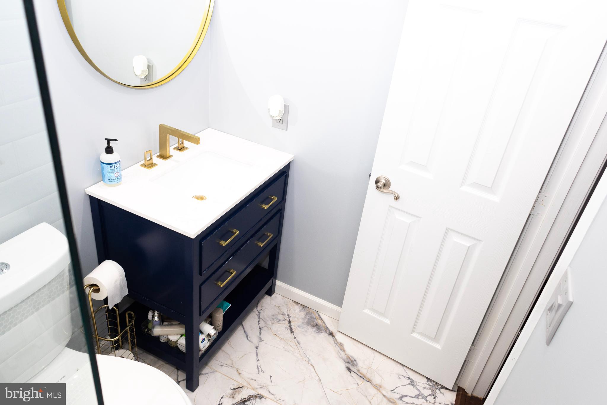 2429 Lizbec Court Crofton, MD 21114 - Photo 20 of 31 a bathroom with a sink vanity and a mirror