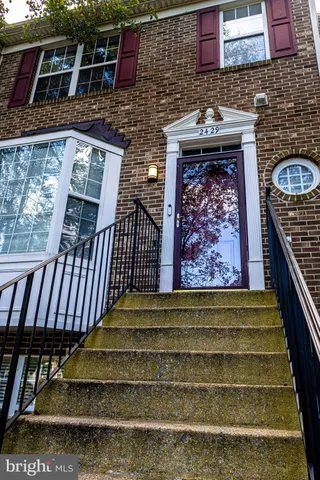 a front view of a house with entryway and wooden floor