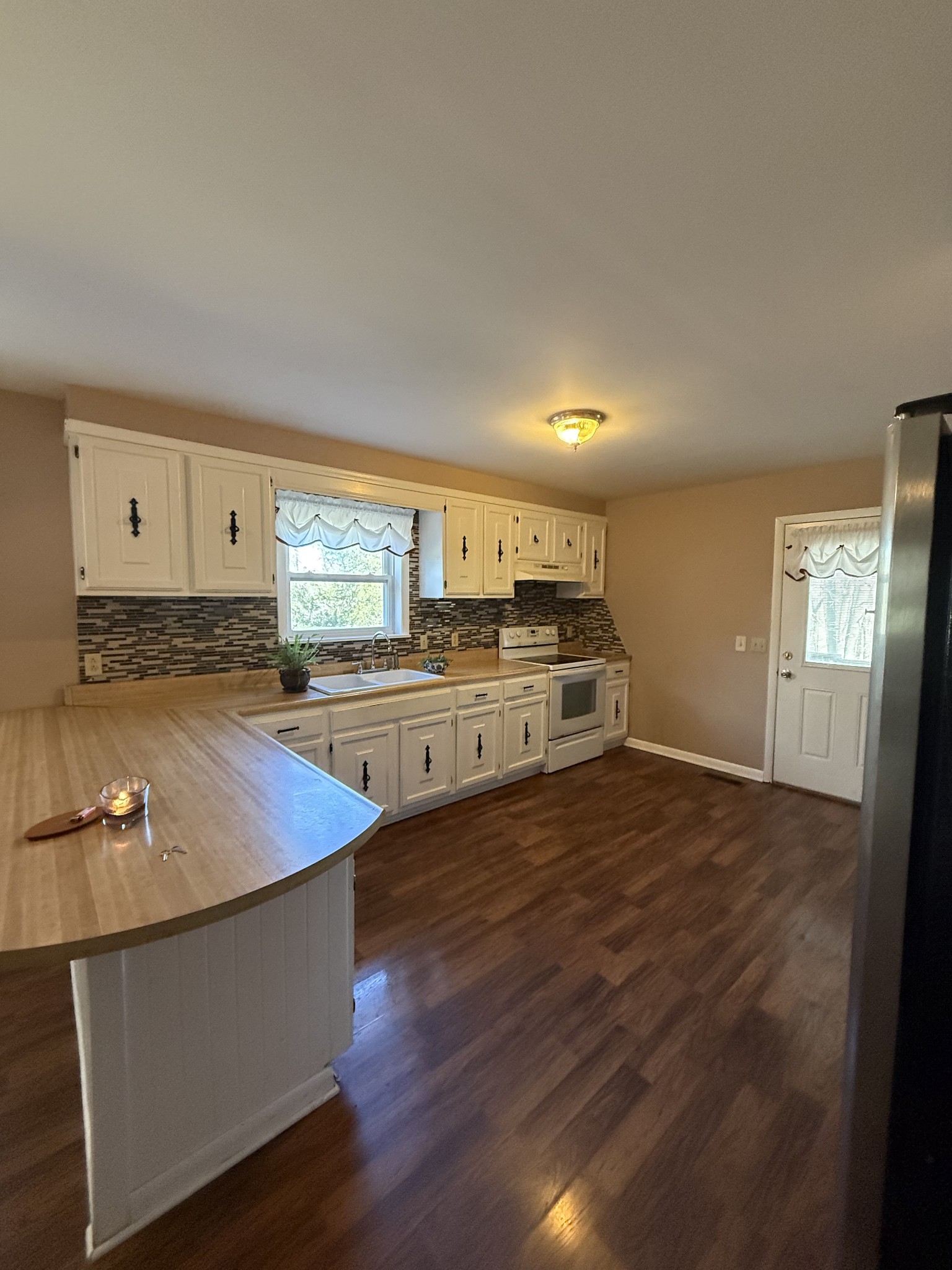 2352 Spring Creek Road Lafayette, TN 37083 - Photo 8 of 11 a kitchen with stainless steel appliances granite countertop a sink counter space and cabinets