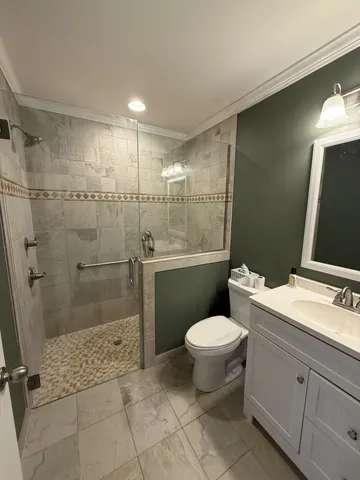 a bathroom with a toilet sink and shower