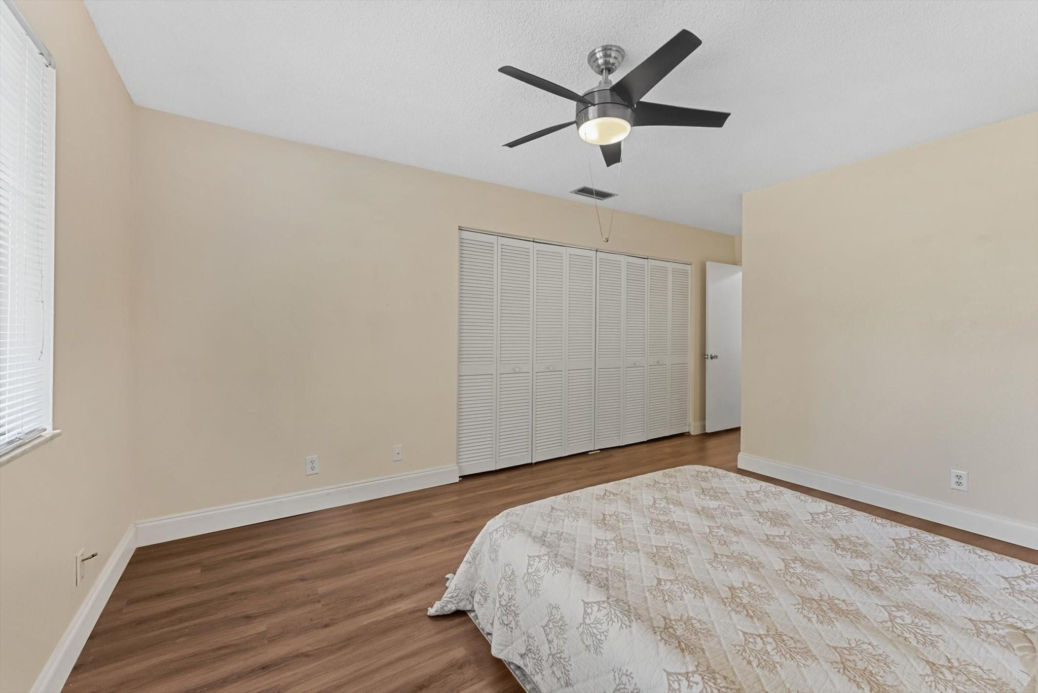 160 Northwest 70th Street, Unit 204 Boca Raton, FL 33487 - Photo 16 of 31 an empty room with wooden floor and windows
