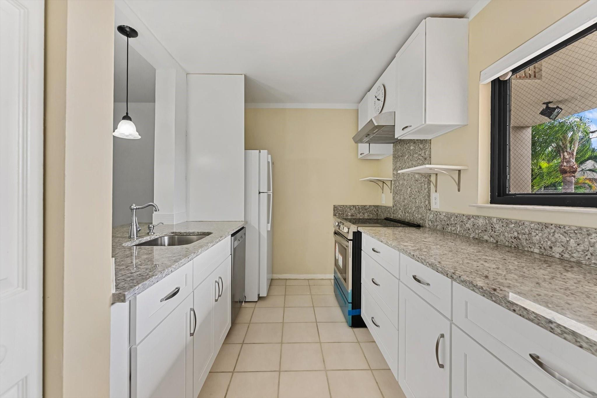 160 Northwest 70th Street, Unit 204 Boca Raton, FL 33487 - Photo 2 of 31 a kitchen with granite countertop a sink and a stove