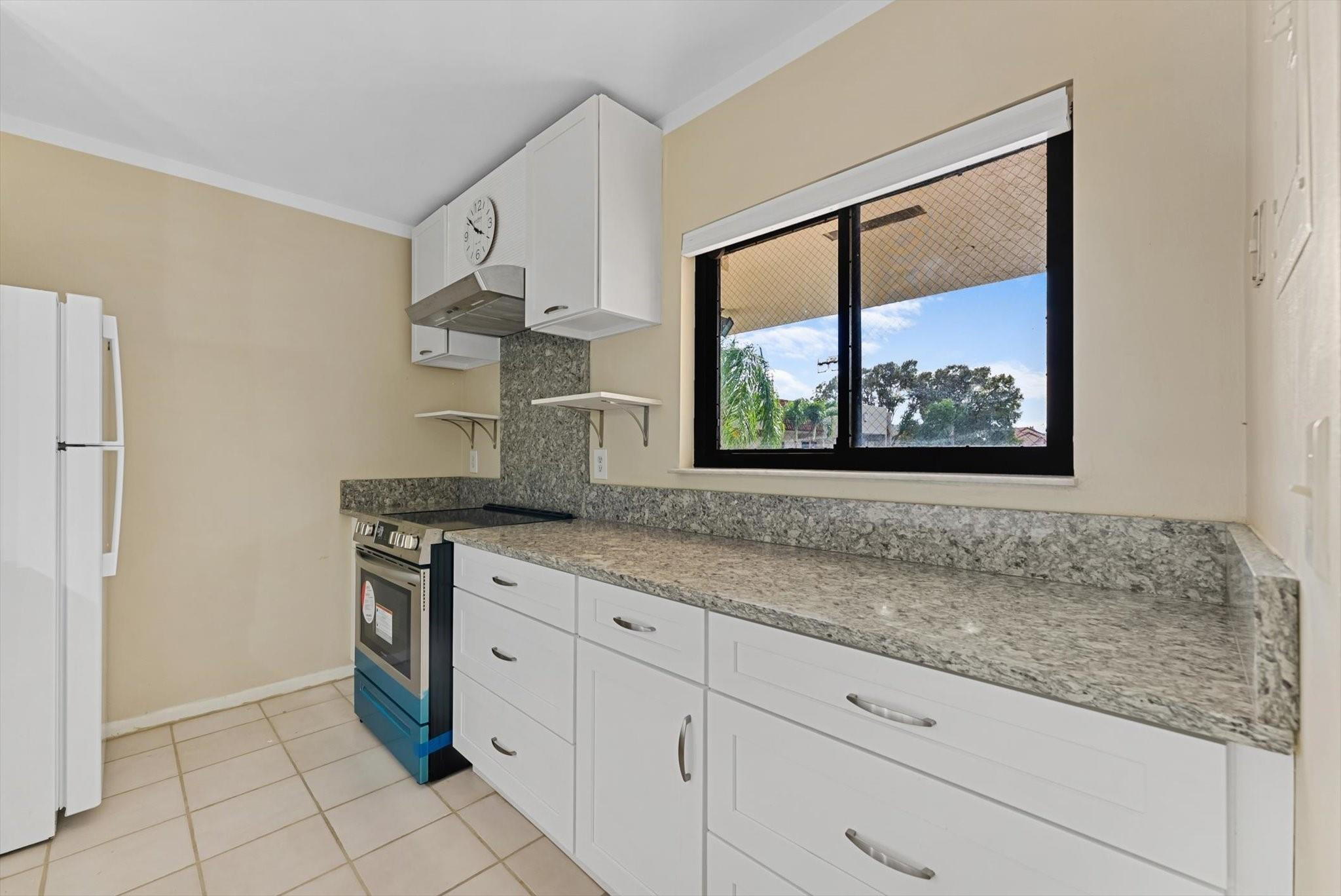 160 Northwest 70th Street, Unit 204 Boca Raton, FL 33487 - Photo 3 of 31 a kitchen with stainless steel appliances granite countertop white cabinets and a window