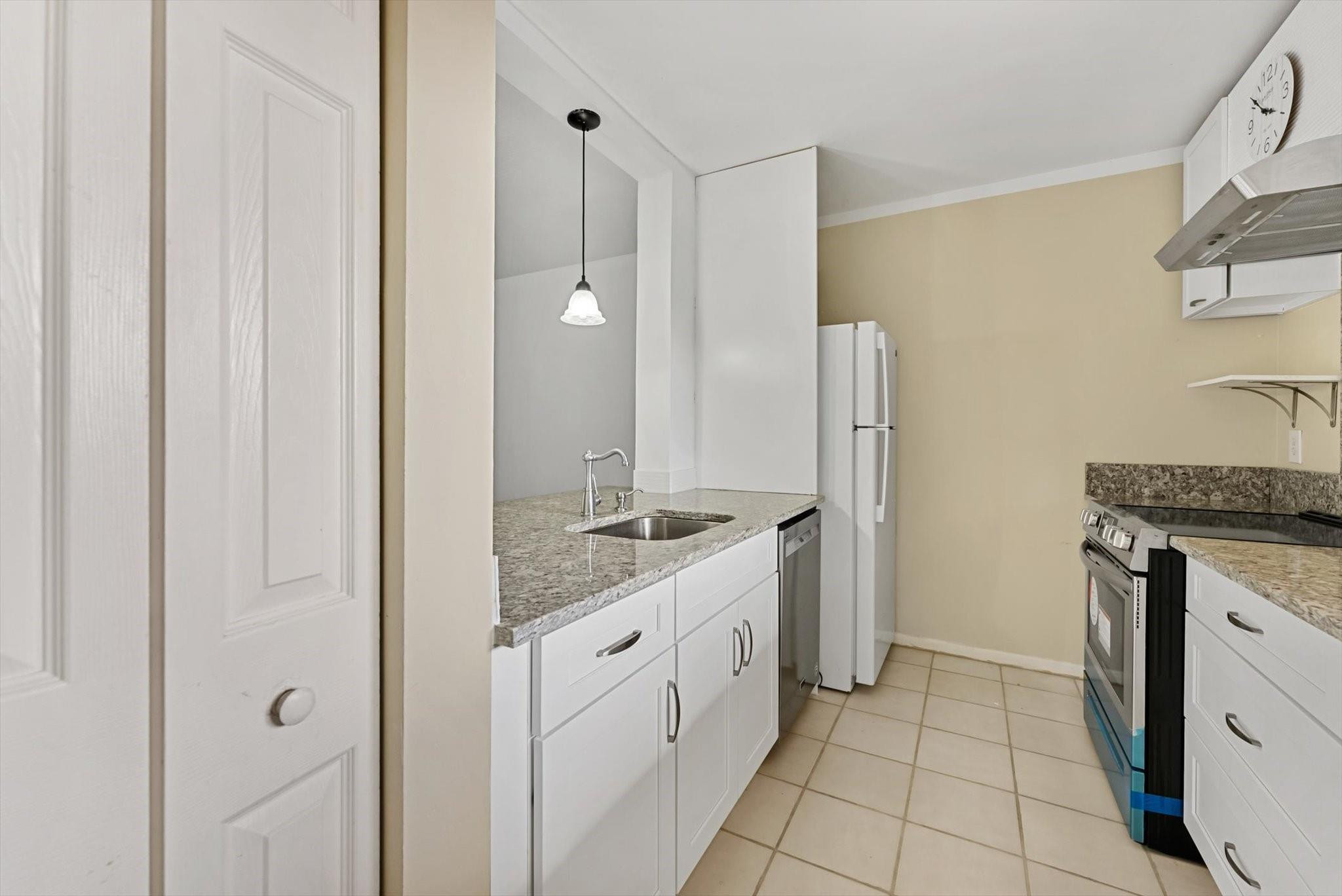 160 Northwest 70th Street, Unit 204 Boca Raton, FL 33487 - Photo 4 of 31 a spacious bathroom with a granite countertop sink a mirror and a shower
