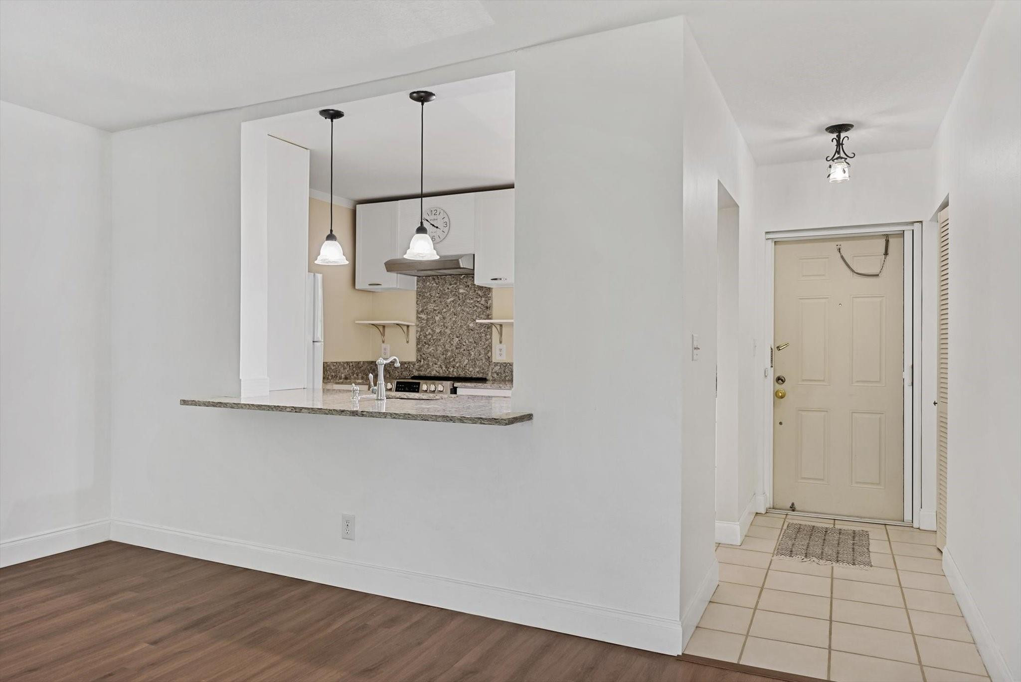 160 Northwest 70th Street, Unit 204 Boca Raton, FL 33487 - Photo 5 of 31 a view of a kitchen with wooden floor and a window
