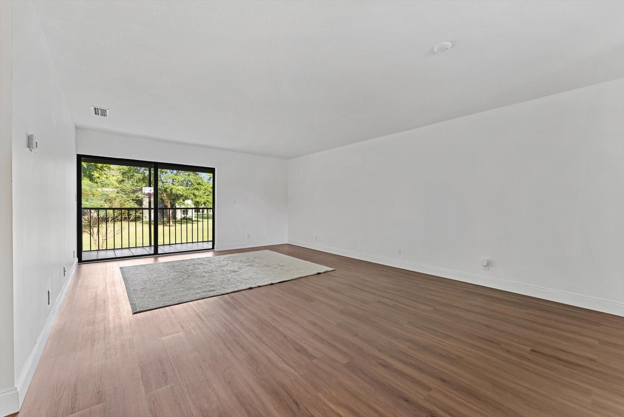 160 Northwest 70th Street, Unit 204 Boca Raton, FL 33487 - Photo 6 of 31 wooden floor in an empty room with a window
