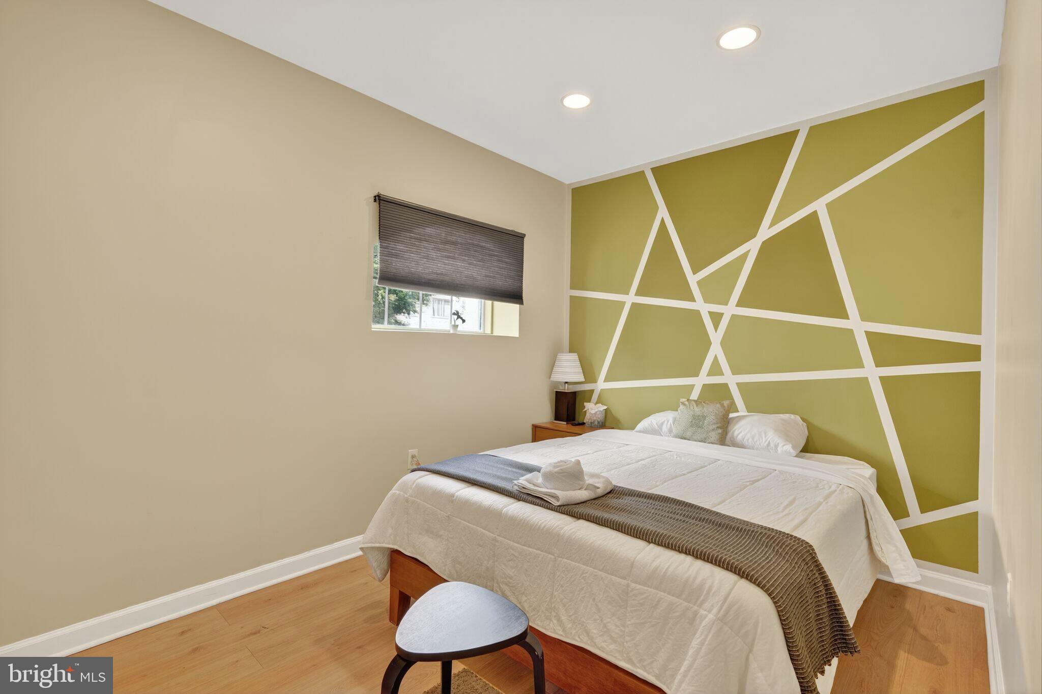 1337 Harvard Street Northwest, Unit 1 Washington, DC 20009 - Photo 11 of 20 a bedroom with a bed and a chair