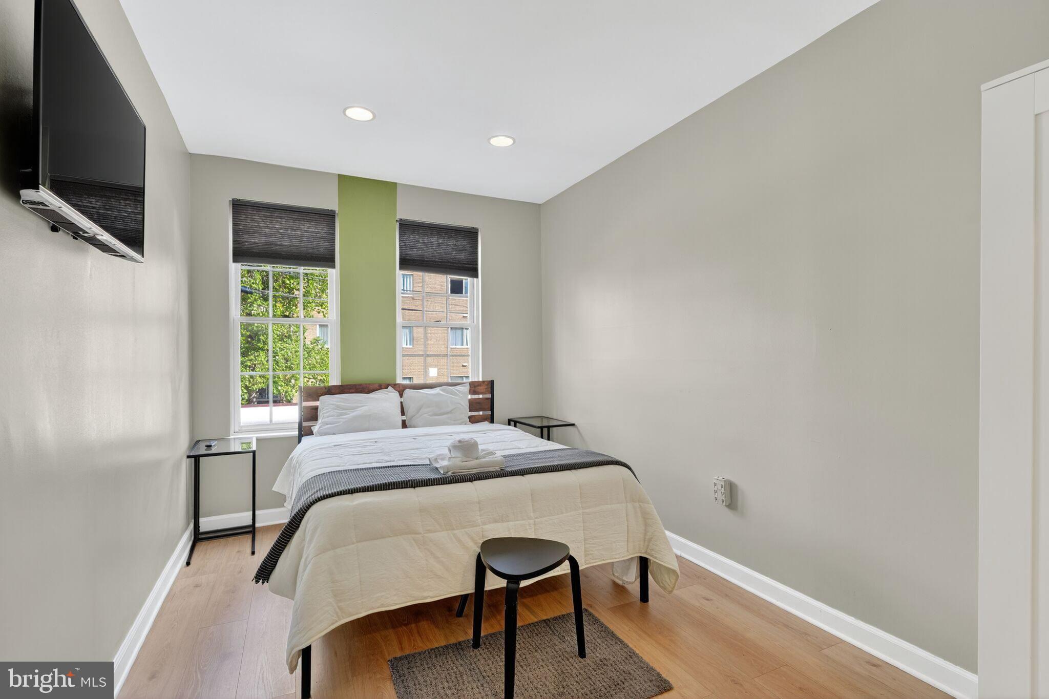 1337 Harvard Street Northwest, Unit 1 Washington, DC 20009 - Photo 12 of 20 a bed sitting in a spacious bedroom next to a window