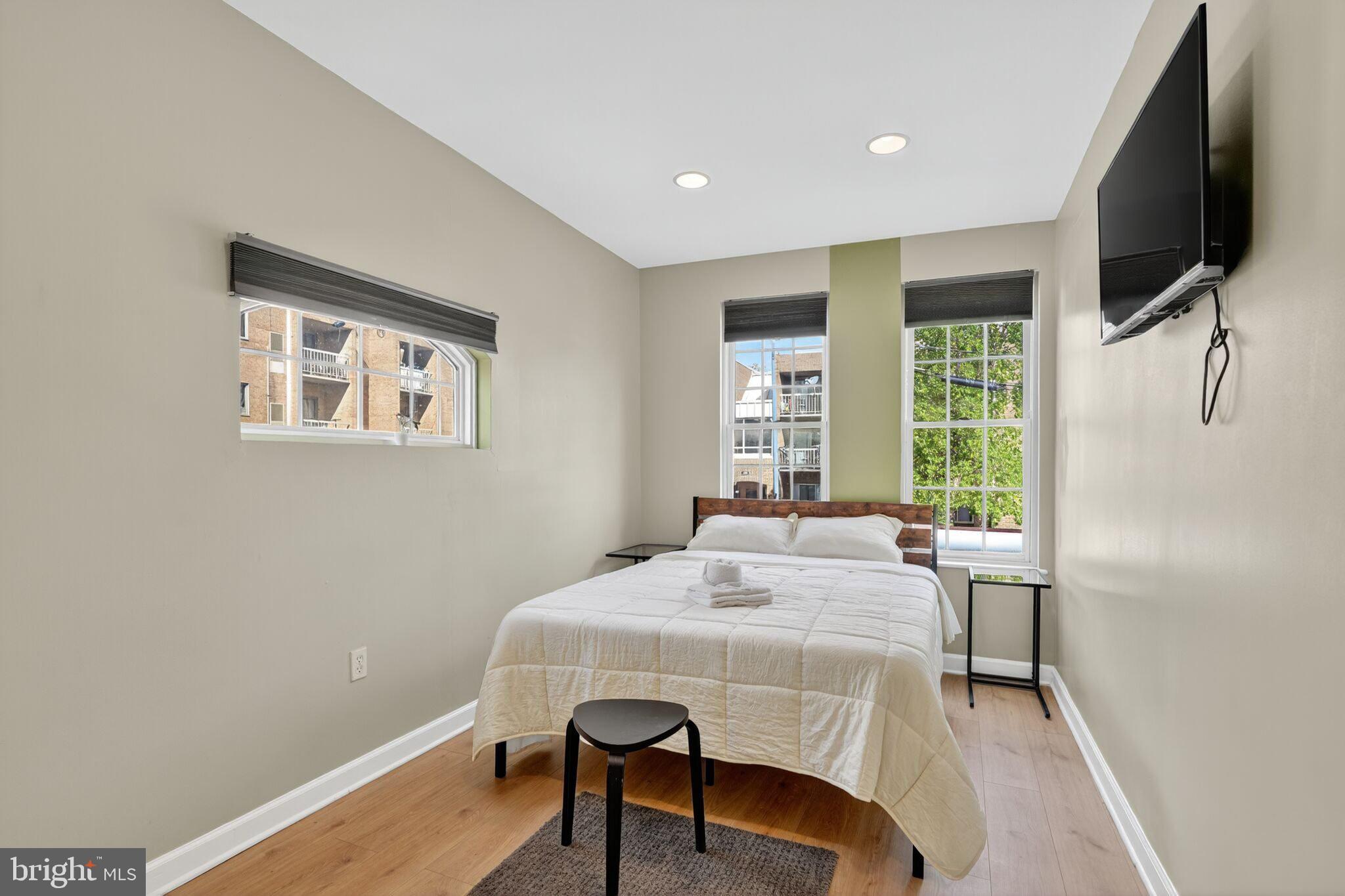 1337 Harvard Street Northwest, Unit 1 Washington, DC 20009 - Photo 13 of 20 a bedroom with a bed and a flat screen tv