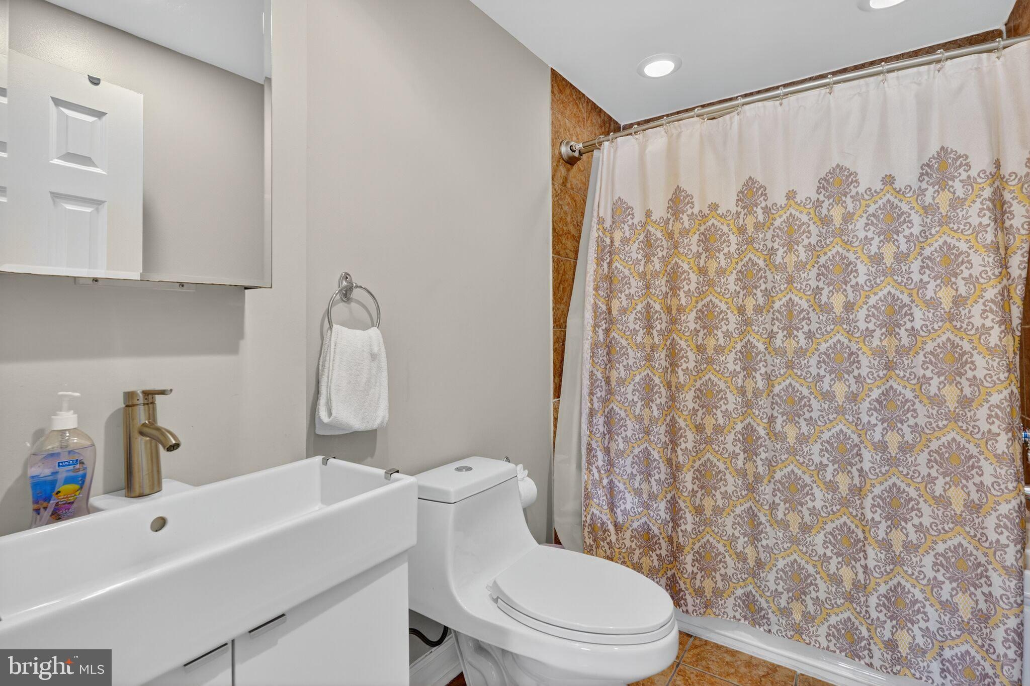 1337 Harvard Street Northwest, Unit 1 Washington, DC 20009 - Photo 15 of 20 a white toilet sitting next to a bathroom sink