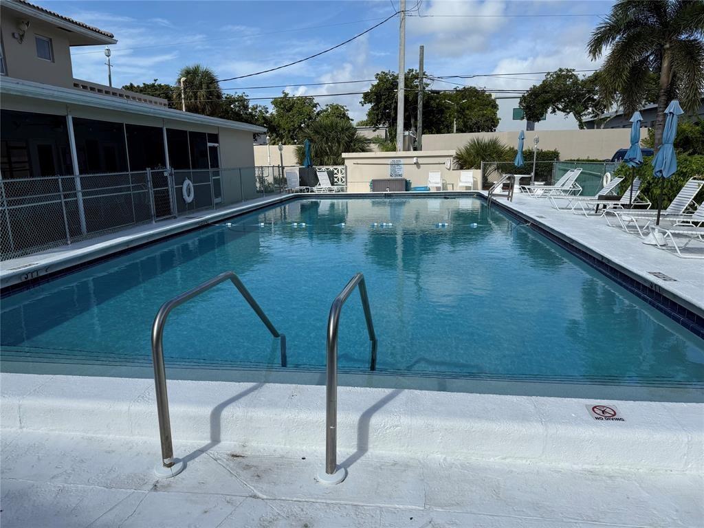 2115 Northeast 42nd Court, Unit 105N Lighthouse Point, FL 33064 - Photo 14 of 17 a view of a swimming pool with a patio
