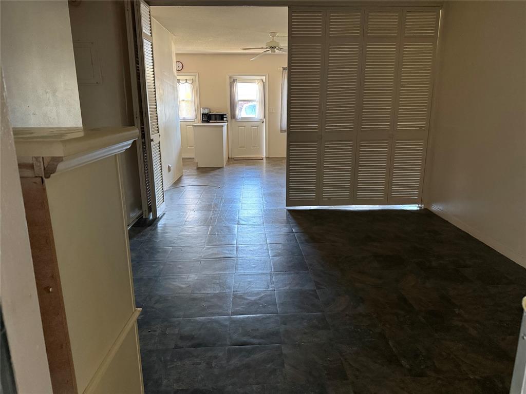 2115 Northeast 42nd Court, Unit 105N Lighthouse Point, FL 33064 - Photo 8 of 17 a view of a hallway with wooden floor and a bathroom
