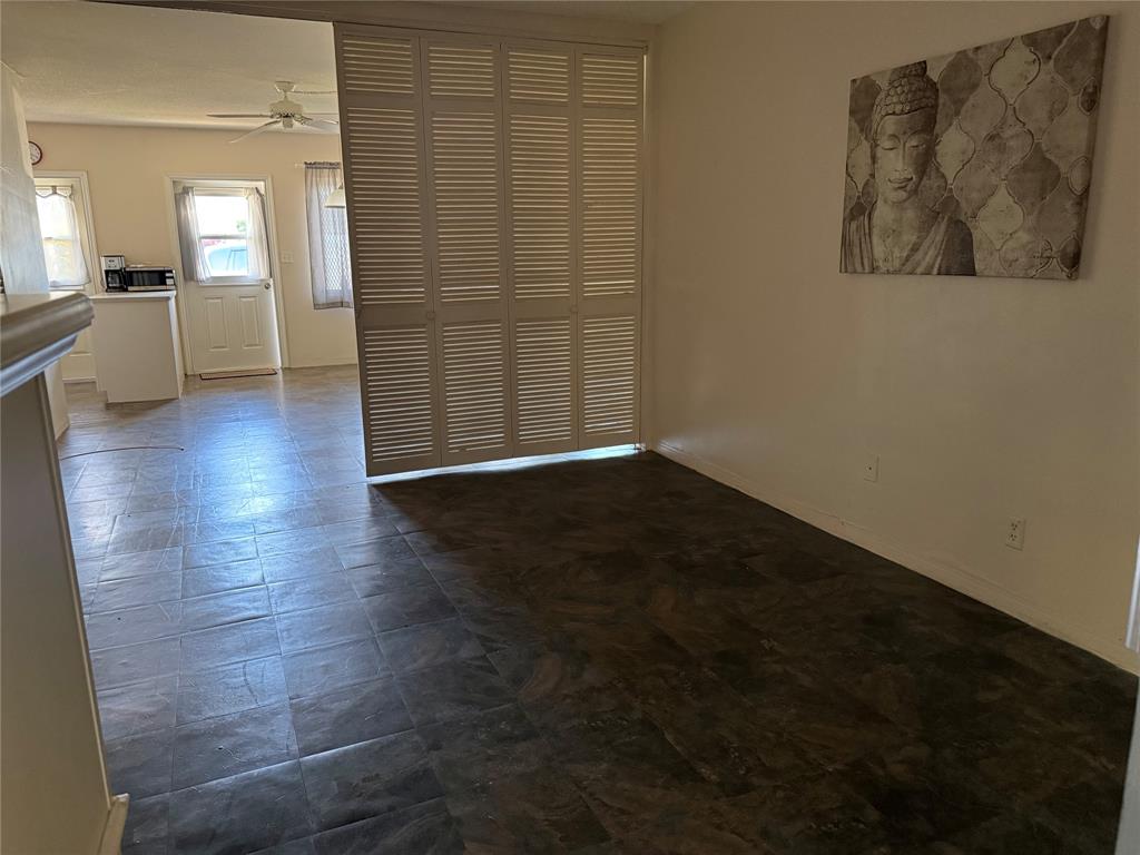 2115 Northeast 42nd Court, Unit 105N Lighthouse Point, FL 33064 - Photo 9 of 17 an empty room with wooden floor and a way to kitchen