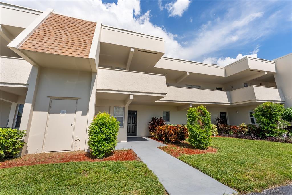 7351 West Country Club Drive North, Unit 103 Sarasota, FL 34243 - Photo 1 of 26 a view of a house with a yard
