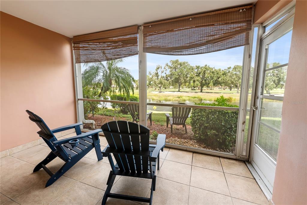 7351 West Country Club Drive North, Unit 103 Sarasota, FL 34243 - Photo 13 of 26 a view of a room with furniture and wooden floor