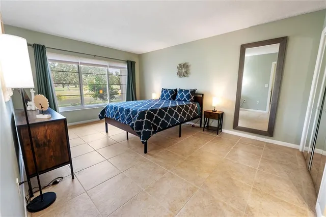 a bedroom with a large bed and a couch