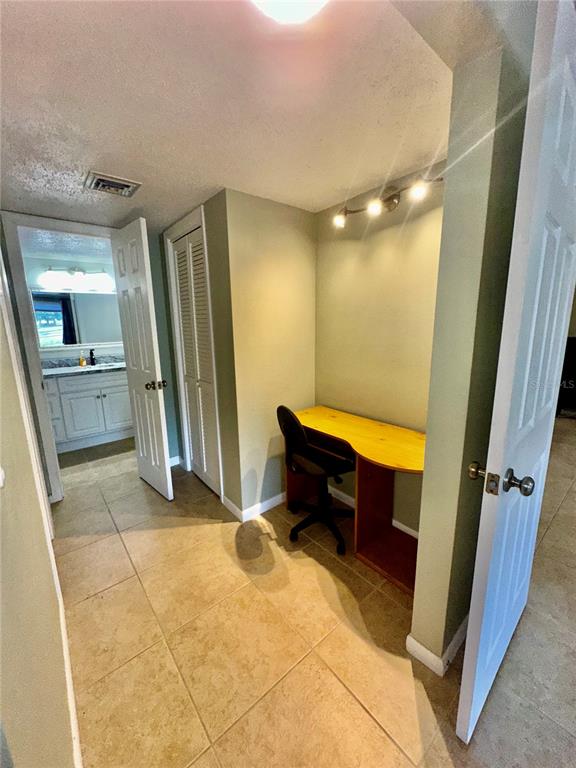 7351 West Country Club Drive North, Unit 103 Sarasota, FL 34243 - Photo 19 of 26 a room with a table and a mirror