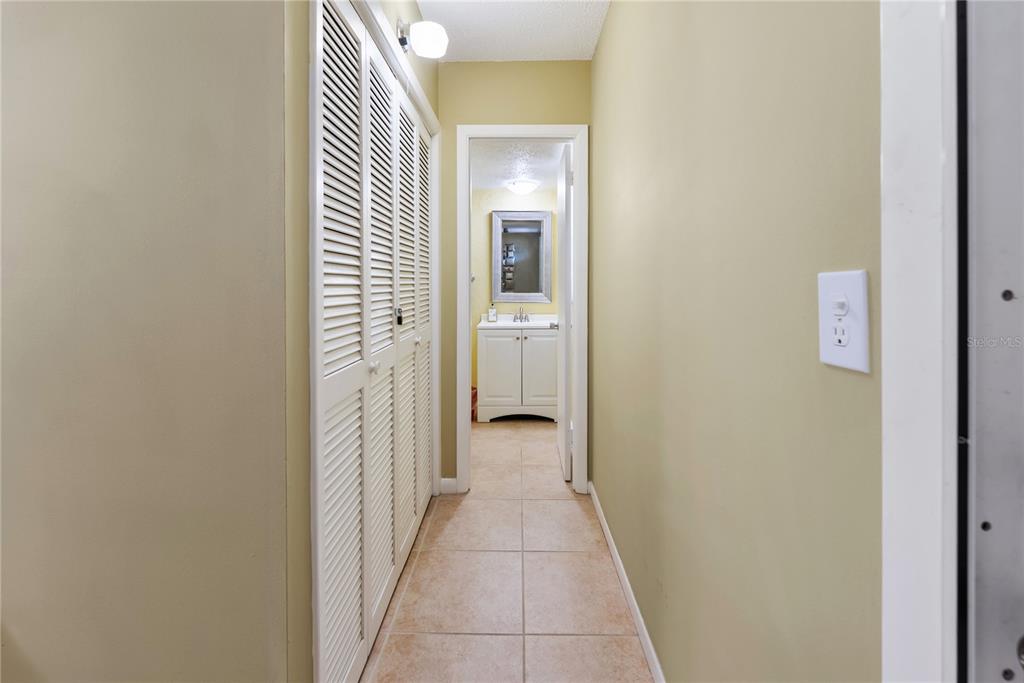 7351 West Country Club Drive North, Unit 103 Sarasota, FL 34243 - Photo 20 of 26 a view of a hallway with a livingroom and a bathroom with a sink