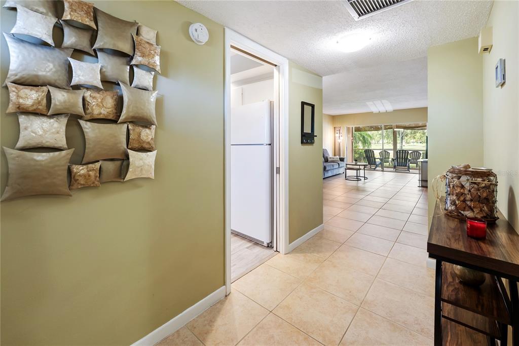 7351 West Country Club Drive North, Unit 103 Sarasota, FL 34243 - Photo 2 of 26 a view of a hallway with seating area