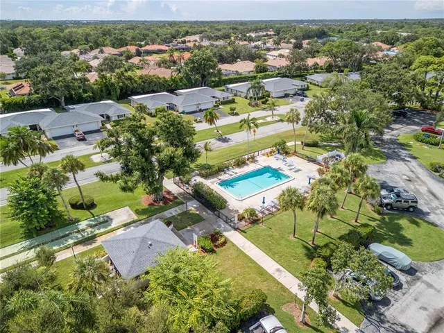 an aerial view of a house with a yard swimming pool and outdoor seating
