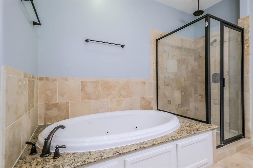 706 Allston Street, Unit B Houston, TX 77007 - Photo 16 of 33 a bathroom with a granite countertop tub shower and mirror