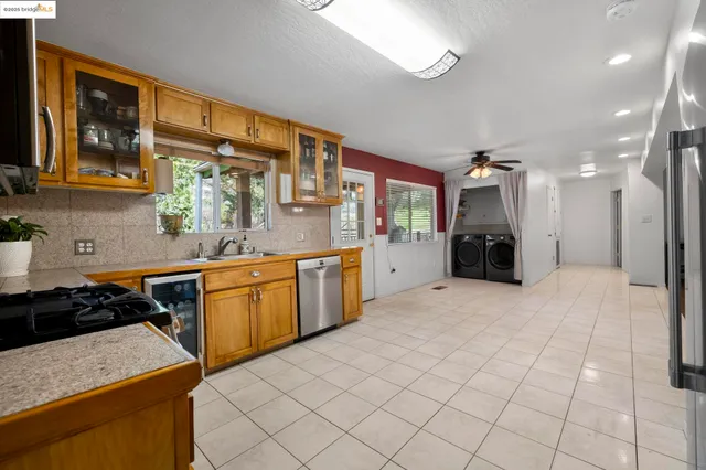 a kitchen with stainless steel appliances kitchen island granite countertop a sink and cabinets