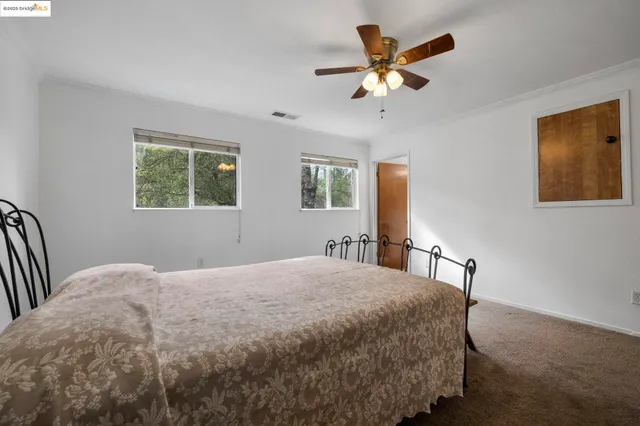 a bedroom with a bed and window