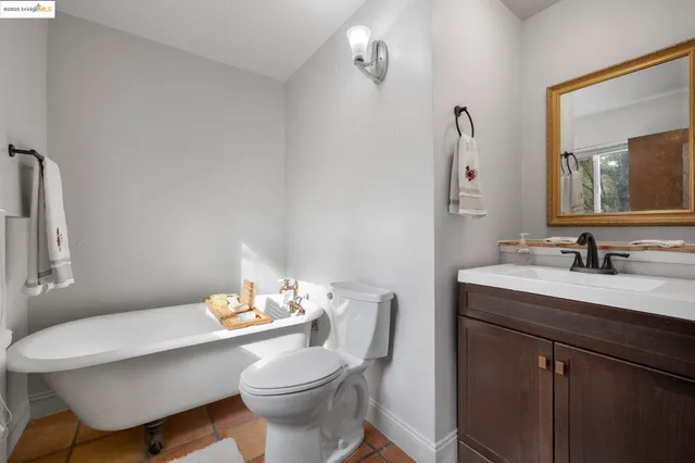 a bathroom with a sink vanity mirror and toilet