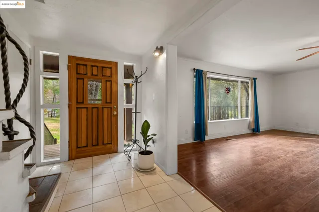 a view of a livingroom with furniture and an entryway