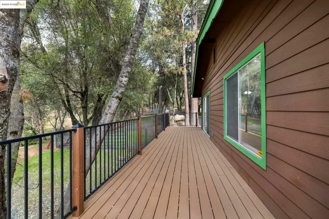 a view of balcony with wooden floor and fence