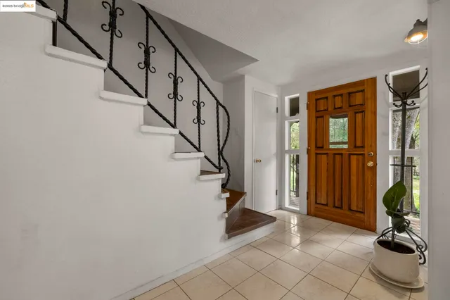 a view of entryway with wooden floor and stairs