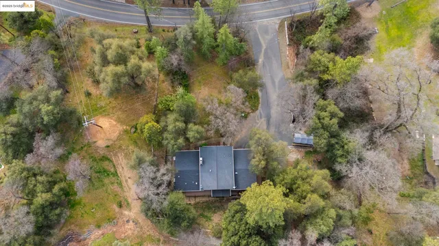 an aerial view of a house with a yard