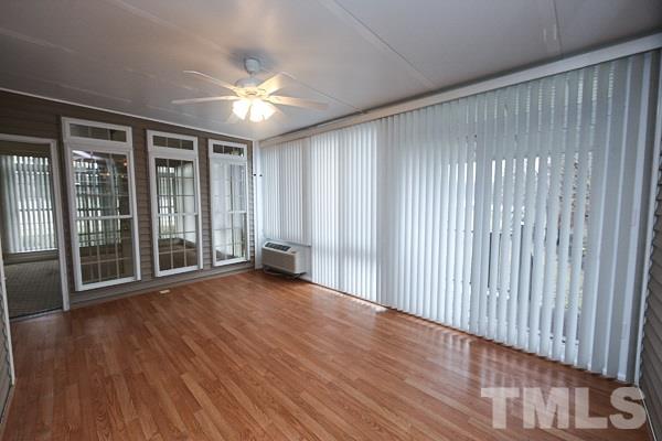 1008 Fieldgrass Place Raleigh, NC 27603 - Photo 11 of 13 wooden floor in an empty room with a window