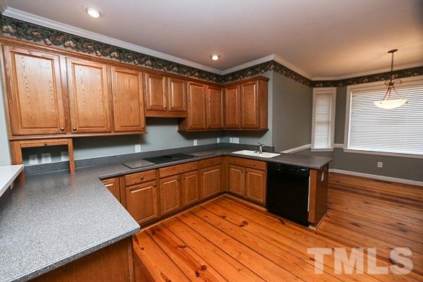 1008 Fieldgrass Place Raleigh, NC 27603 - Photo 3 of 13 a kitchen with granite countertop wooden cabinets a sink and a stove