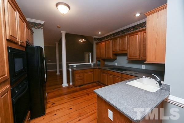1008 Fieldgrass Place Raleigh, NC 27603 - Photo 4 of 13 a kitchen with stainless steel appliances granite countertop a sink a stove and a refrigerator