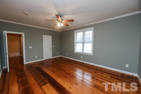 1008 Fieldgrass Place Raleigh, NC 27603 - Photo 8 of 13 a view of an empty room with wooden floor and a window