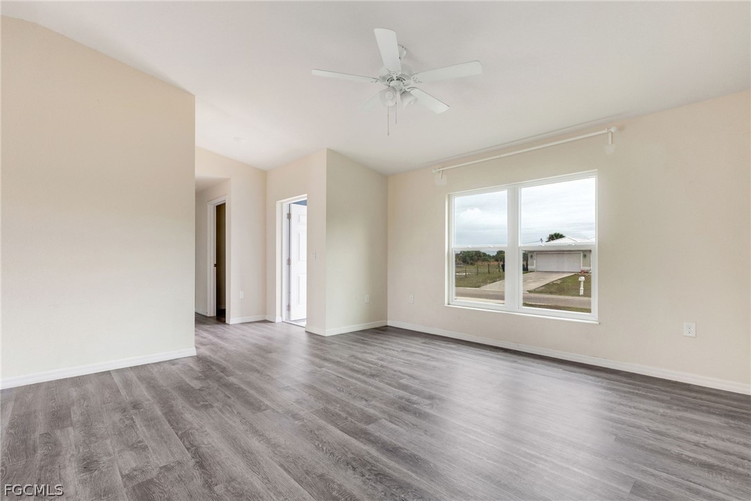 1405 Inwood Road LaBelle, FL 33935 - Photo 10 of 35 an empty room with wooden floor and windows