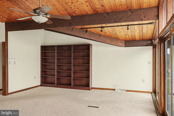 a bedroom with bed and a large window