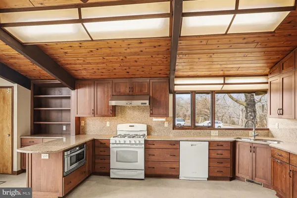 a view of a small space with wooden floor and a window