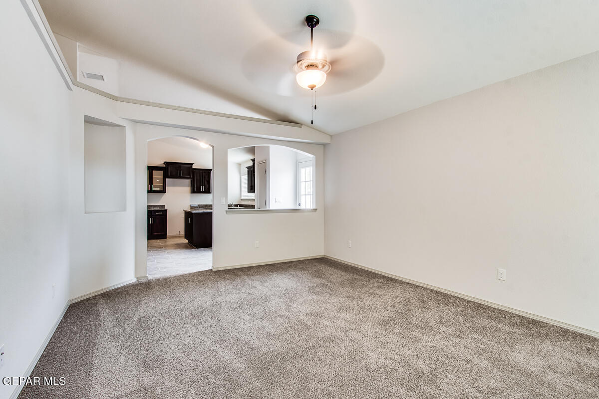 12420 Oconee Place Clint, TX 79836 - Photo 6 of 27 a view of a big room with windows and kitchen view