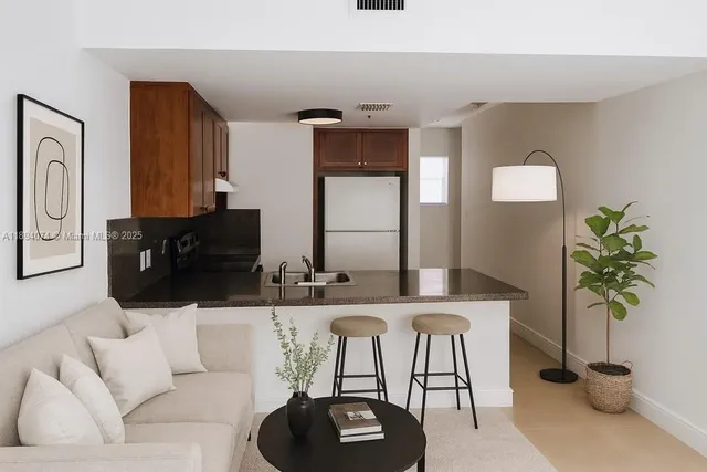 a living room with furniture and a potted plant