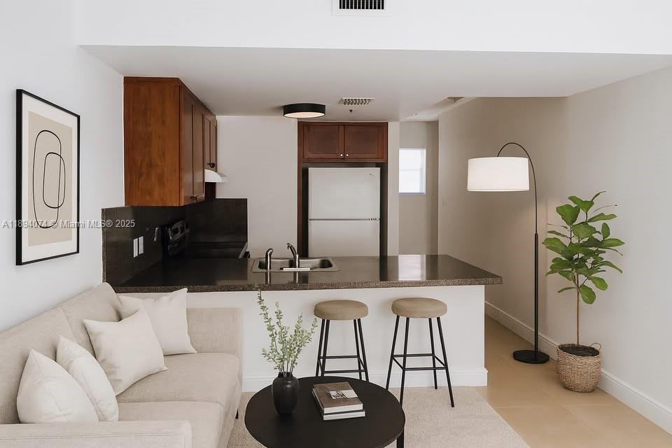 a living room with furniture and a potted plant
