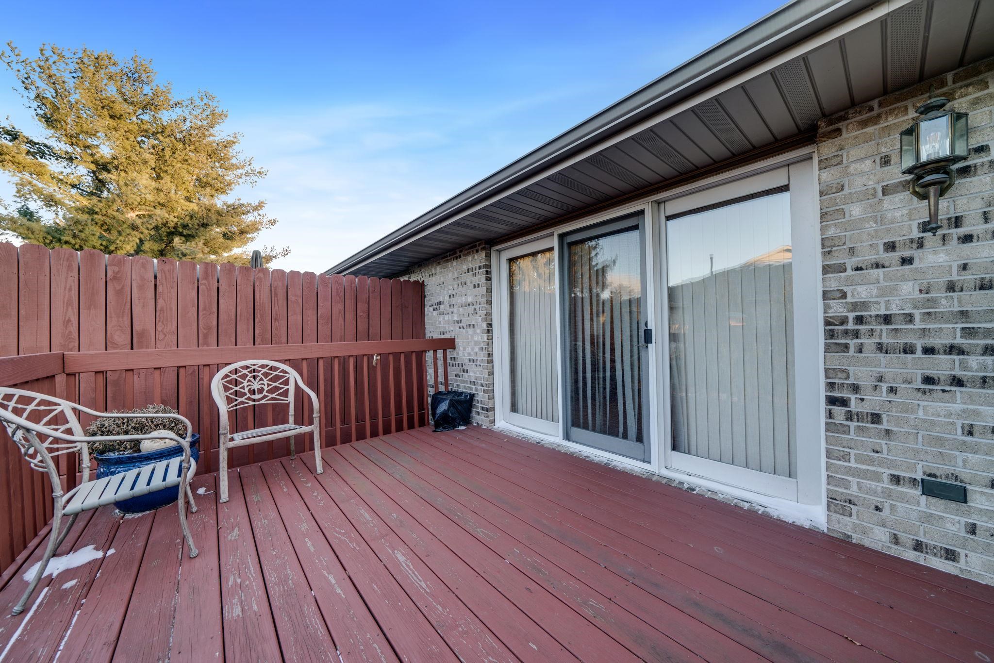 1196 South Trainer Road Rockford, IL 61108 - Photo 30 of 33 a view of a wooden deck with table and chairs