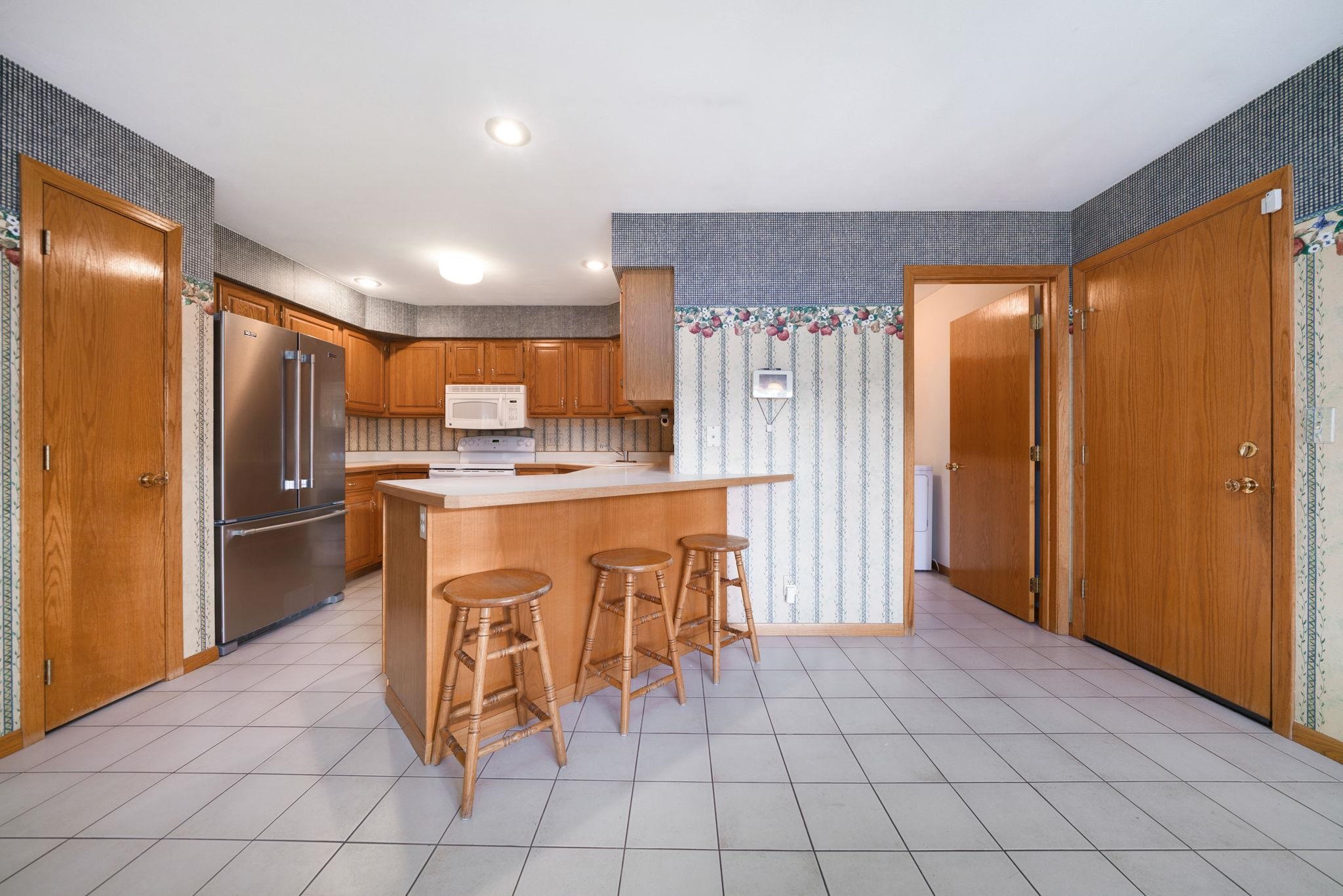 1196 South Trainer Road Rockford, IL 61108 - Photo 3 of 33 a kitchen with stainless steel appliances a refrigerator sink and cabinets