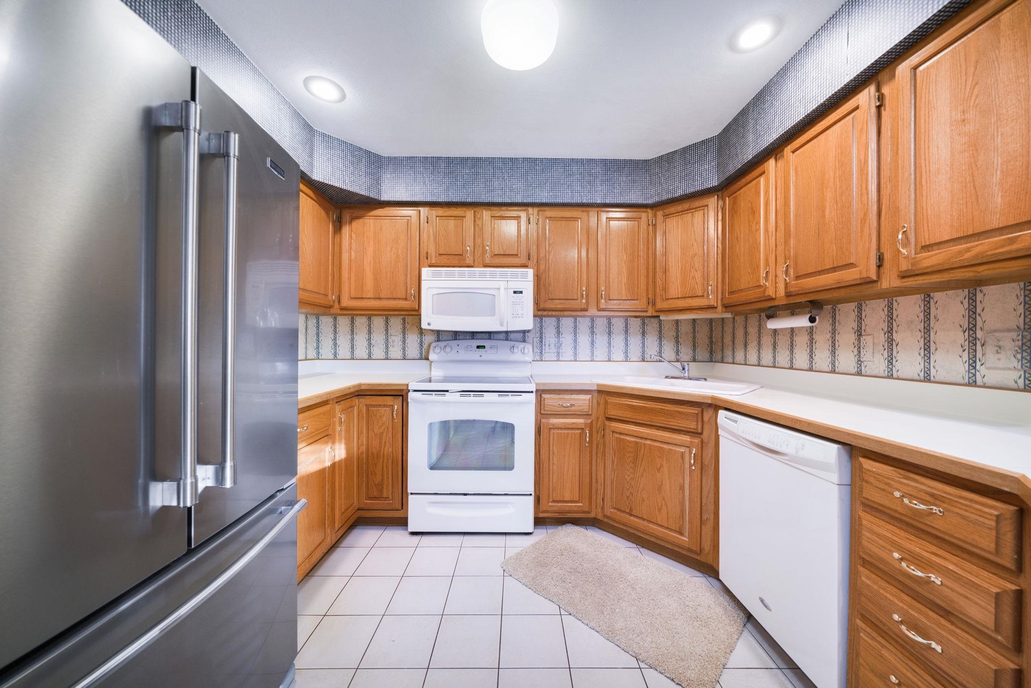 1196 South Trainer Road Rockford, IL 61108 - Photo 5 of 33 a kitchen with stainless steel appliances granite countertop a stove a sink and a refrigerator