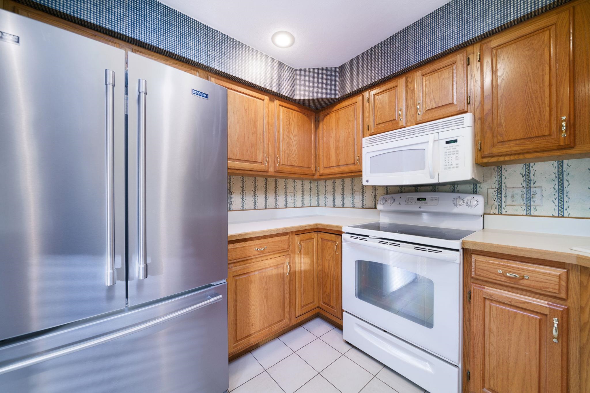 1196 South Trainer Road Rockford, IL 61108 - Photo 6 of 33 a kitchen with stainless steel appliances granite countertop a refrigerator sink and cabinets