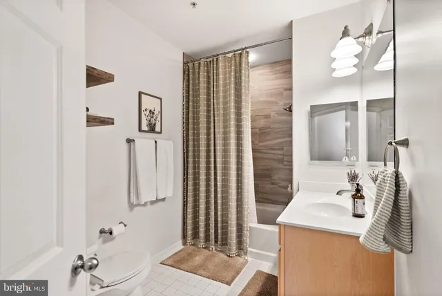 a living room with furniture a wooden floor and next to a window