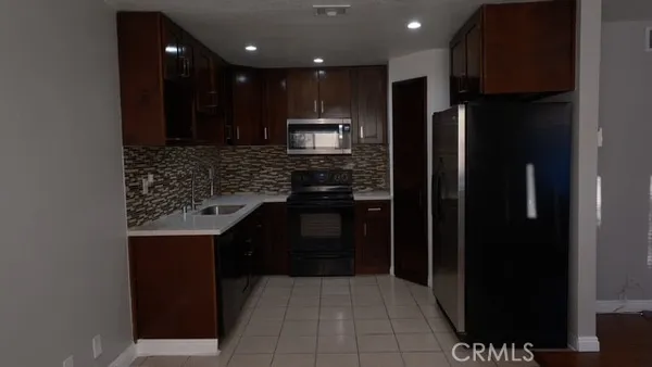 a stove top oven sitting inside of a kitchen